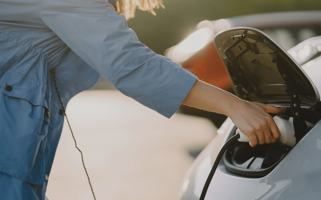 woman using electric car charger in orange county to charge ev