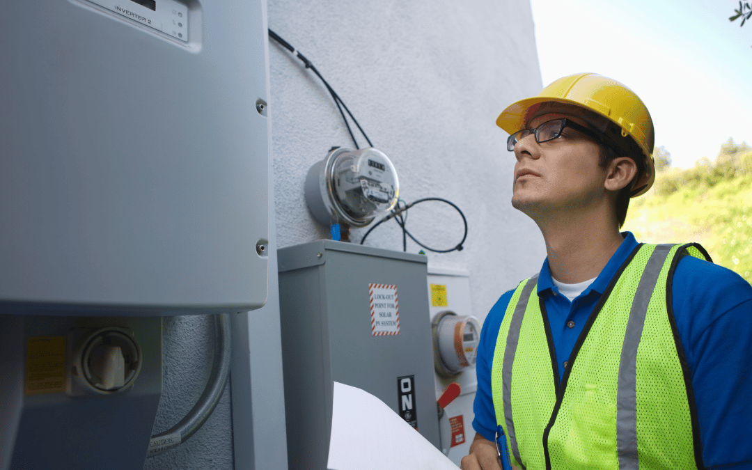 solar panel installer in anaheim examining a solar panel system