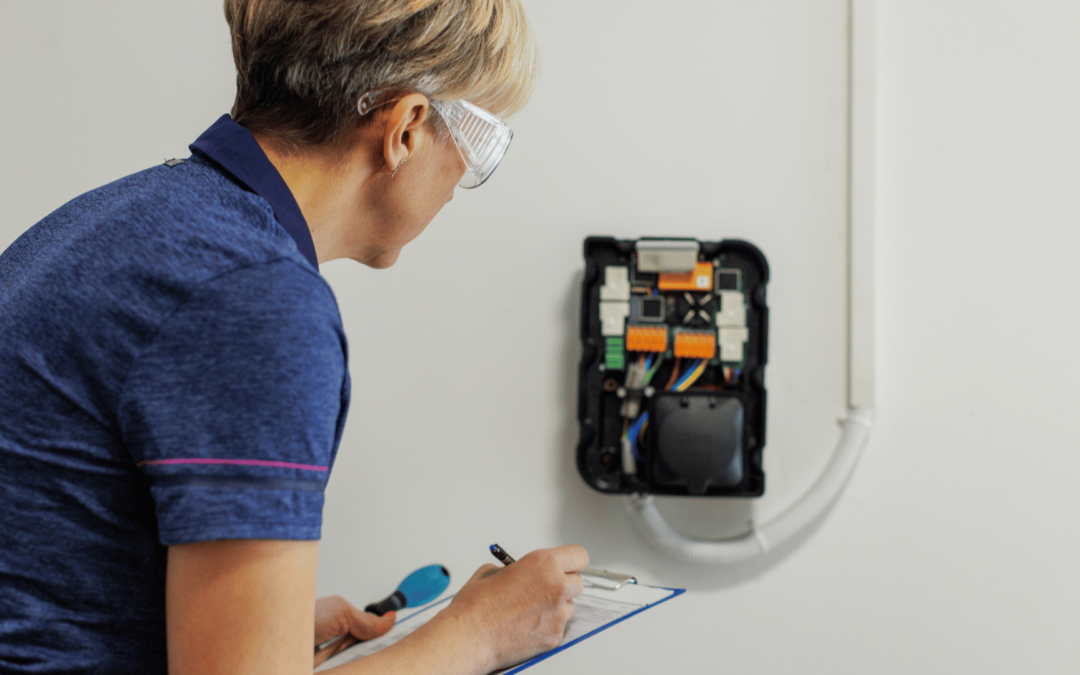 woman inspecting commercial ev charger for commercial ev charger maintenance in orange county