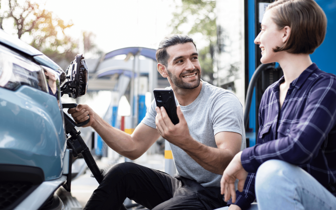 two people charging an electric vehicle at a public ev charging station in orange county, showcasing the convenience and accessibility of local ev infrastructure