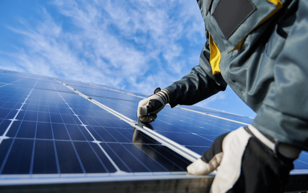 Close-up of a technician installing solar panels on a commercial rooftop in Orange County, showcasing the importance of professional installation for grid-tied solar systems